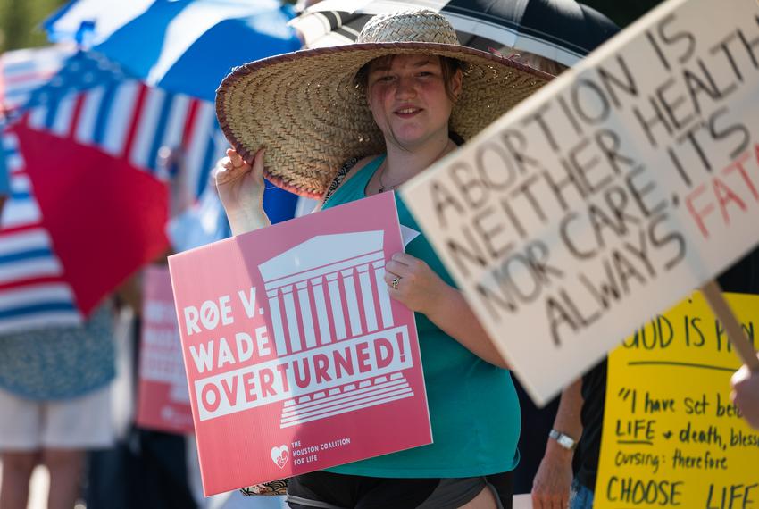 Vienne Crook holds a sign supporting the Supreme Court’s design to overturn Roe v. Wade at a rally in support of the court’s decision in front of Planned Parenthood’s offices Friday, June 24, 2022, in Houston. (Justin Rex for The Texas Tribune)
